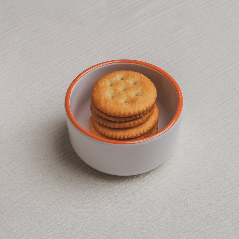 The crackers Macro Bowl filled with golden round crackers.