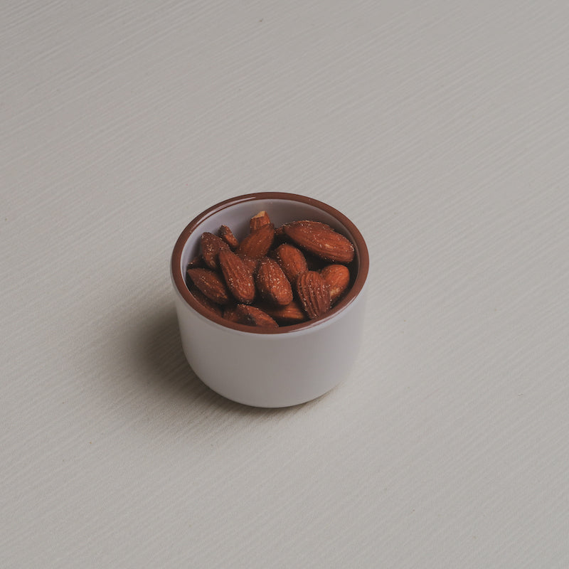 A slightly angled view of the nuts Macro Bowl filled with almonds.