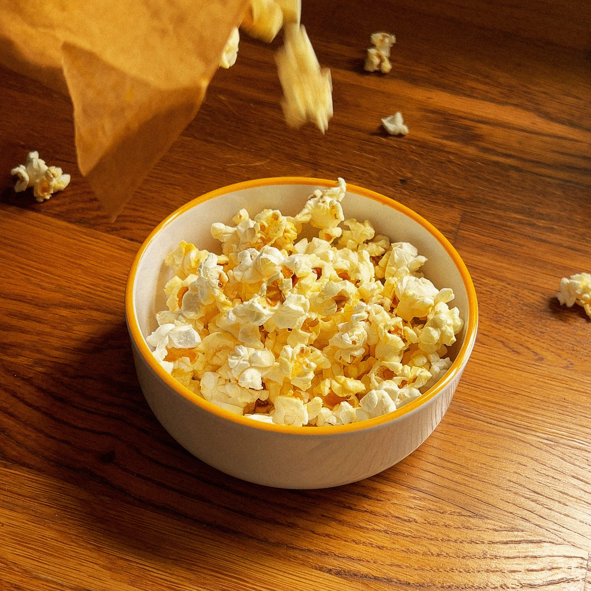 Filling the Macro popcorn bowl with microwaved buttered popcorn.